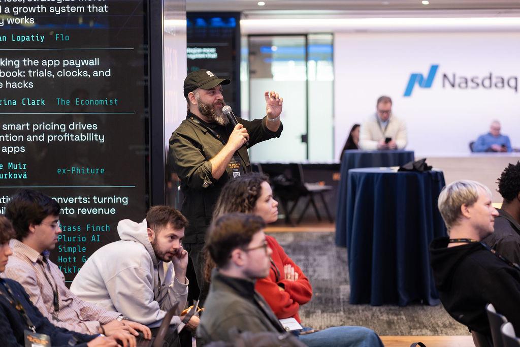 An attendee asking a question from the floor at the AIM Conference