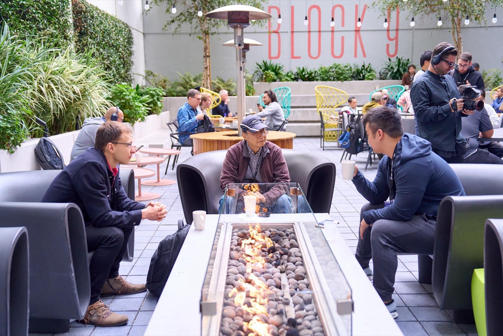 Attendees gathered around an outdoor fire pit lounge at the dAGI Summit